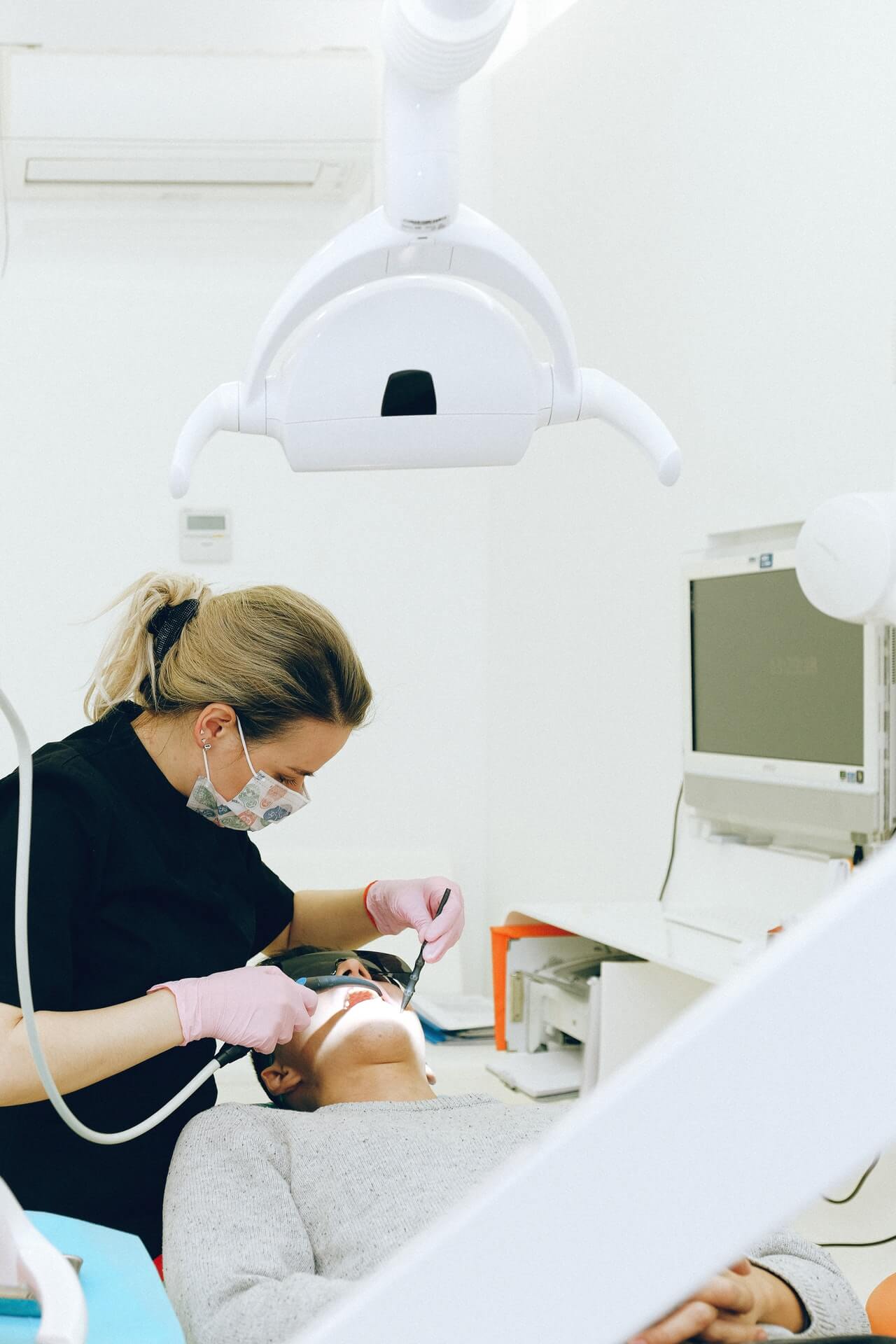 Dentist performing root canal treatment for a patient with dental infection